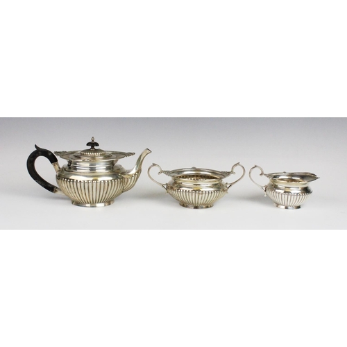 54 - A Victorian three-piece silver tea service by Walker & Hall, Sheffield 1899, comprising teapot, milk... 