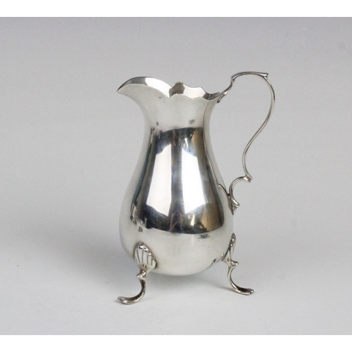 7 - An Edwardian silver cream jug by Jay, Richard Attenborough & Co, Chester 1903, of baluster form with... 
