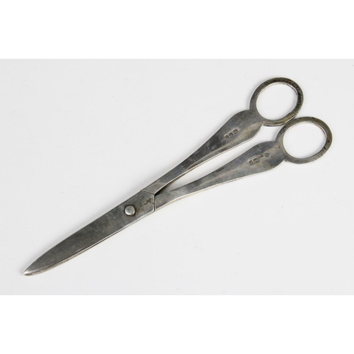 78 - A pair of Victorian silver grape scissors, London 1896 (maker's marks worn), engraved with green man... 