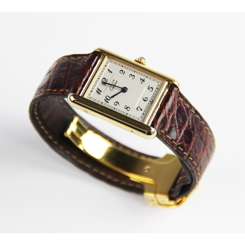 153 - A lady's Must de Cartier silver gilt Tank Vermeil wristwatch, the rectangular cream dial with Arabic... 