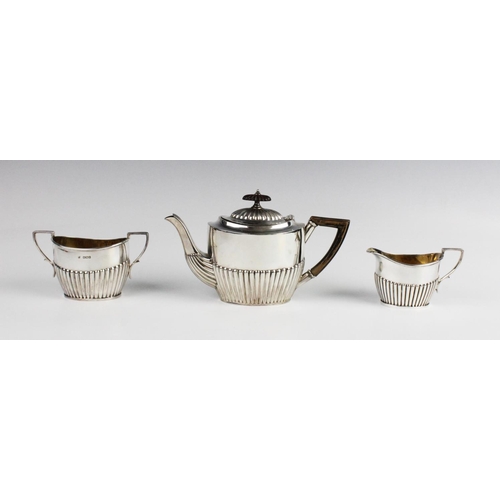 74 - A matched silver three-piece bachelor tea service, comprising a teapot, sucrier and milk jug, each o... 