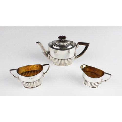 74 - A matched silver three-piece bachelor tea service, comprising a teapot, sucrier and milk jug, each o... 