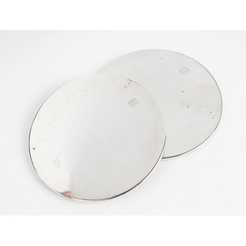 77 - A pair of silver mounted coasters by Barker Ellis Silver Co, Birmingham 1970, of plain polished circ... 