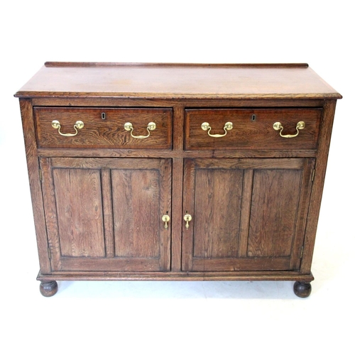 963 - A 19th century oak dresser base/sideboard, the rectangular moulded top above two frieze drawers and ... 