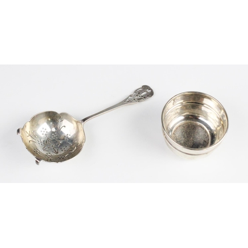 97 - An Arts & Crafts style silver tea strainer and stand by Emile Viner, Sheffield 1935, the bowl with p... 