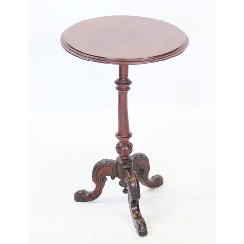 1017 - A mid 19th century mahogany lamp table, the circular top on a turned column and three leaf carved do... 