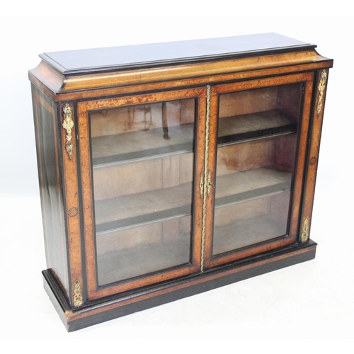 1026 - A Victorian ebonised and burr thuya glazed bookcase, the pagoda shaped top above a pair of glazed do... 