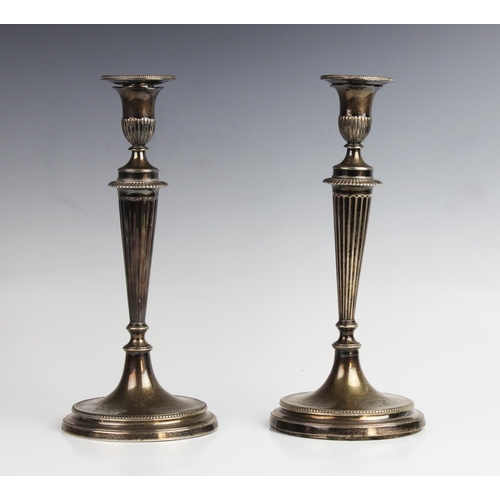 145 - A pair of late 19th century white metal candlesticks, each with urn shaped sconces and detachable no... 