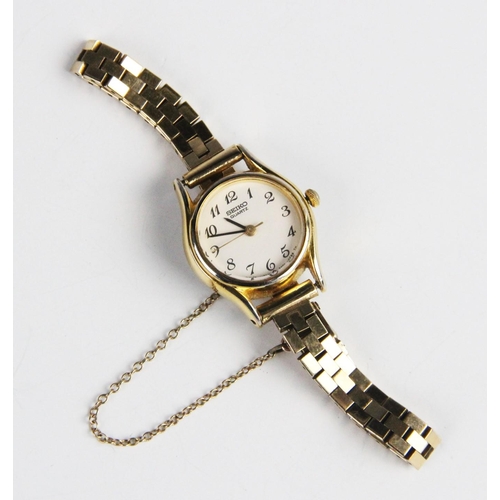 175 - A lady's Seiko quartz wristwatch on 9ct gold strap, the round white dial with Arabic numeral, set to... 