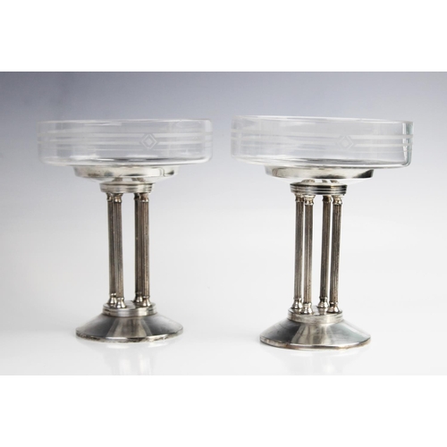 380 - A pair of Art Deco tazzas, the shallow glass dishes with etched geometric motifs, raised on white me... 