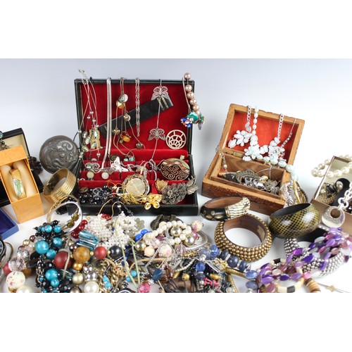 246 - A large collection of vintage and modern costume jewellery, including beaded necklaces, chains, bang... 