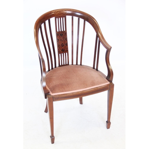 1034 - An Edwardian mahogany tub chair, the down swept top rail above a central pierced splat inlaid with l... 