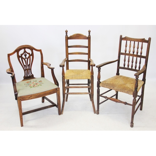 970 - A 19th century oak spindle back elbow chair, with an envelope rush seat on turned legs and plain cro... 