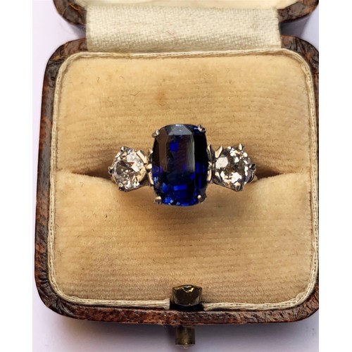 218 - A sapphire and diamond three stone ring, the central cushion cut sapphire (9.2mm x 6.4mm x 5.9mm, ap... 