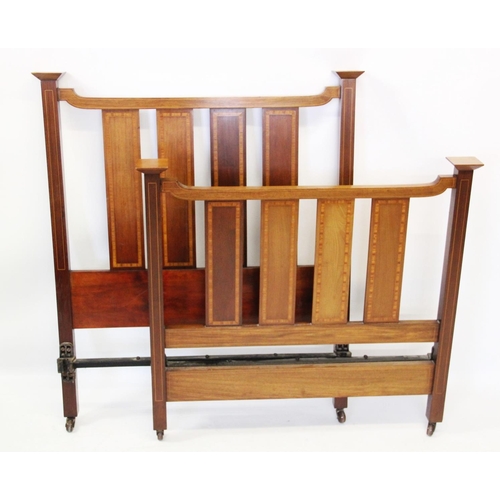 1033 - A pair of Edwardian mahogany slatted single beds, with satinwood crossbanded vertical rails, raised ... 