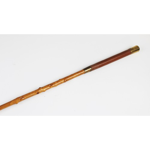 418 - An early 20th century carriage whip by Swaine and Adeney, with a leather handle and gilt metal mount... 