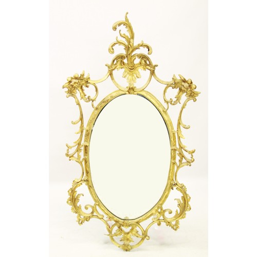 1027 - A late 19th/early 20th century French Rococo style gilt wood wall mirror, the oval mirror plate encl... 