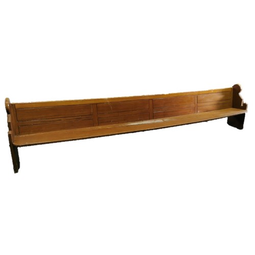 955 - A very large late 19th/early 20th century scumbled/painted pitch pine pew, raised on standard suppor... 