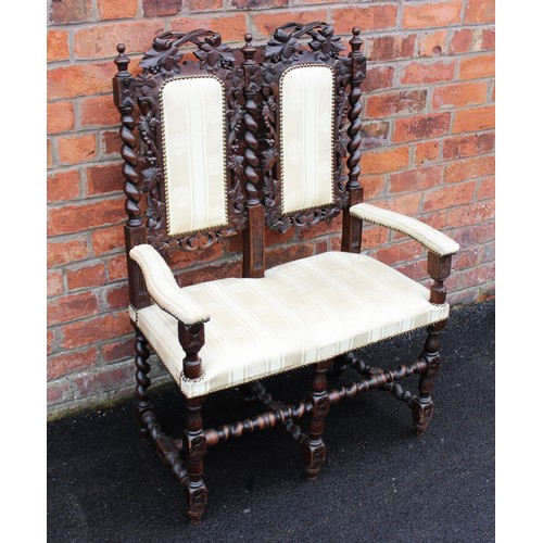 1028 - A 17th century style carved oak twin seat chair, with later padded back rest and seat, raised upon b... 