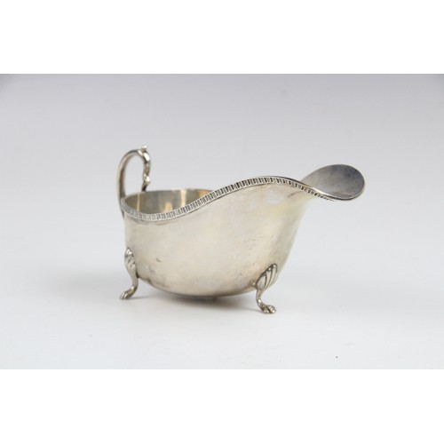 53 - A silver sauce boat by Saunders & Mackenzie, Birmingham 1954, of typical form with gadroon rim and s... 