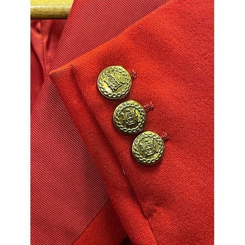 420 - A scarlet evening hunt jacket with tails and gilt buttons, satin lined, 110cm long, along with a sca... 