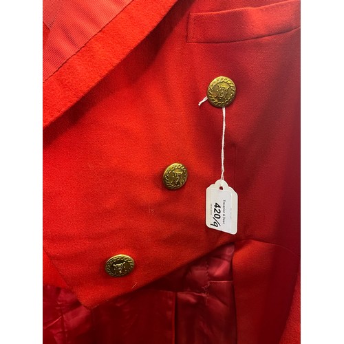 420 - A scarlet evening hunt jacket with tails and gilt buttons, satin lined, 110cm long, along with a sca... 