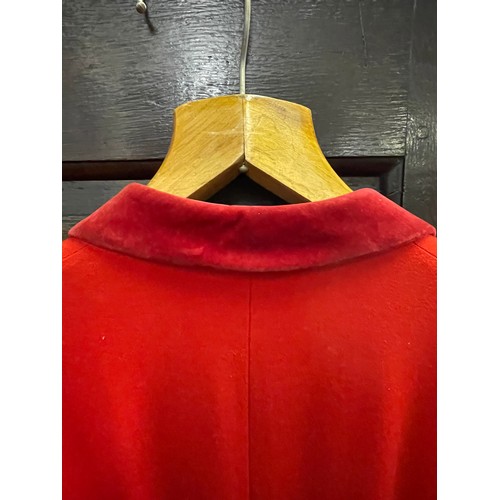 420 - A scarlet evening hunt jacket with tails and gilt buttons, satin lined, 110cm long, along with a sca... 