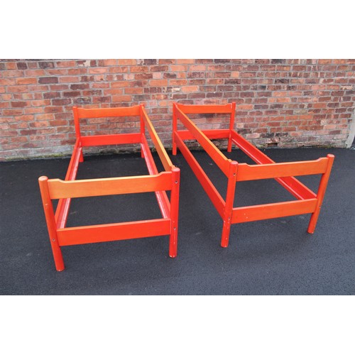 1042 - Two late 20th century stained beech wood Magistretti single beds, the rail head and foot boards supp... 