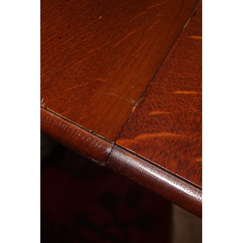 1029 - An early 20th century golden oak extending dining table, the rectangular top with moulded and rounde... 