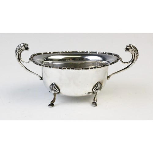 50 - A George V twin-handled silver sugar bowl by E Hill, Birmingham 1934, of oval form with shaped borde... 