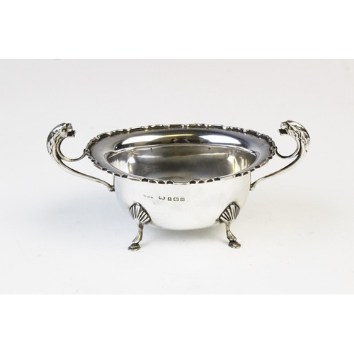 50 - A George V twin-handled silver sugar bowl by E Hill, Birmingham 1934, of oval form with shaped borde... 
