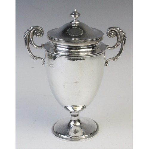 46 - An Edwardian silver twin-handled trophy cup and cover by William Hutton & Sons, London 1905, the urn... 