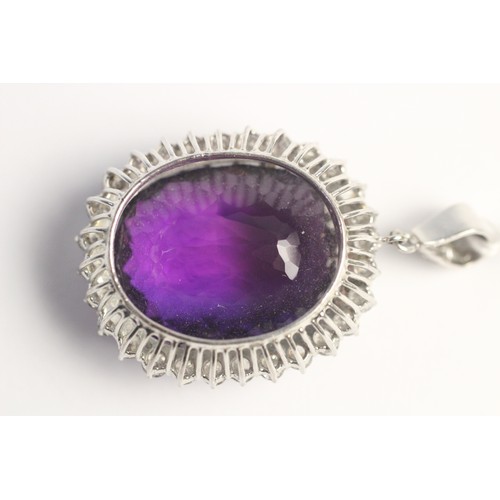 259 - An amethyst and diamond pendant, the central cushion cut amethyst measuring approx. 28mm x 23mm x 17... 