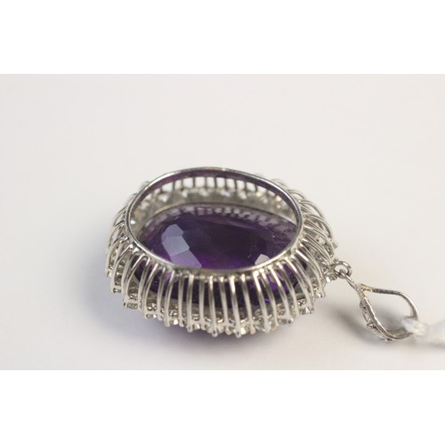 259 - An amethyst and diamond pendant, the central cushion cut amethyst measuring approx. 28mm x 23mm x 17... 