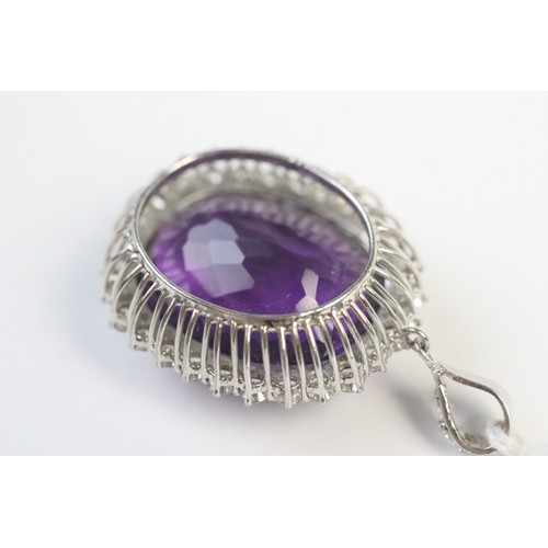 259 - An amethyst and diamond pendant, the central cushion cut amethyst measuring approx. 28mm x 23mm x 17... 