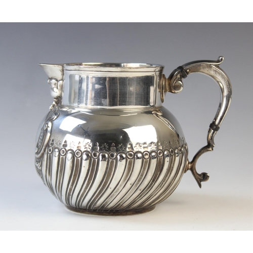 1 - A George V silver jug, Elkington & Co, Birmingham 1923, of spherical form with scroll handle, the lo... 