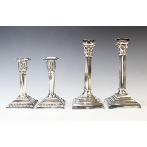 116 - A pair of silver plated candlesticks, each designed as a reeded column with palm leaf wrapped capita... 