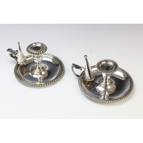 116 - A pair of silver plated candlesticks, each designed as a reeded column with palm leaf wrapped capita... 