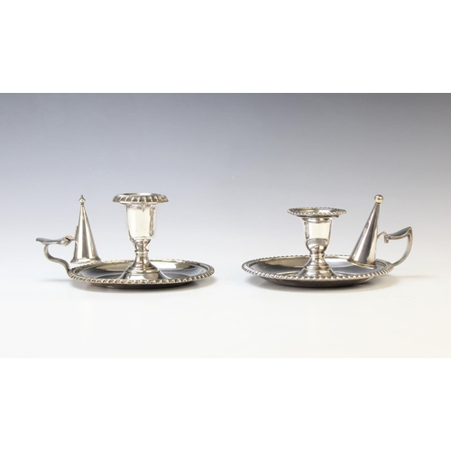 116 - A pair of silver plated candlesticks, each designed as a reeded column with palm leaf wrapped capita... 