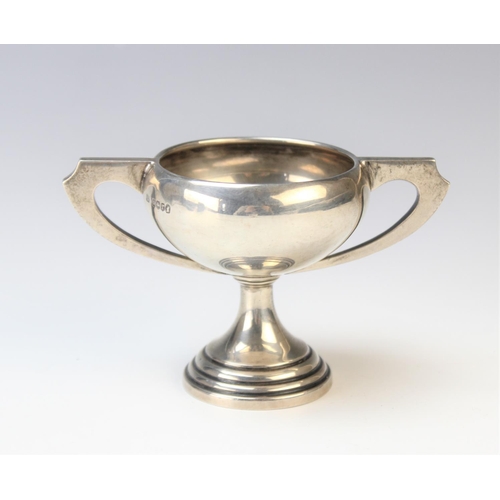 20 - An Art Deco miniature silver twin-handled trophy by Emile Viner, Sheffield 1934, of compressed form ... 