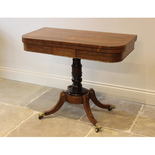 552 - A George IV brass inlaid rosewood pedestal card table, the folding top inlaid with a frieze of brass... 