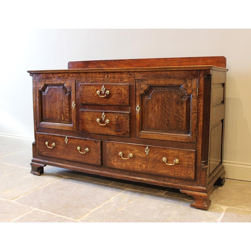 553 - A George III oak and mahogany crossbanded dresser base, later converted from a Lancashire mule chest... 