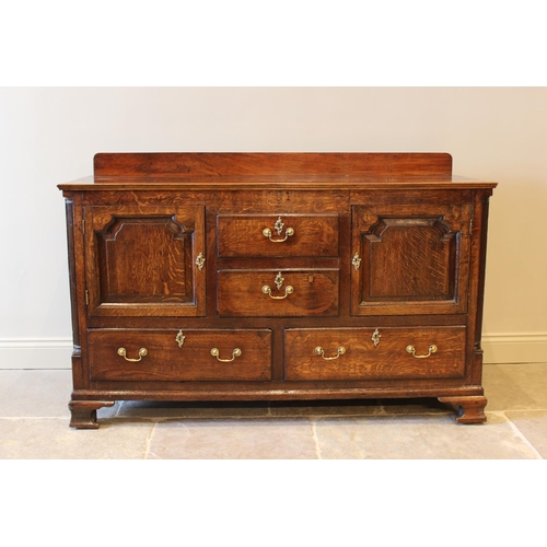 553 - A George III oak and mahogany crossbanded dresser base, later converted from a Lancashire mule chest... 