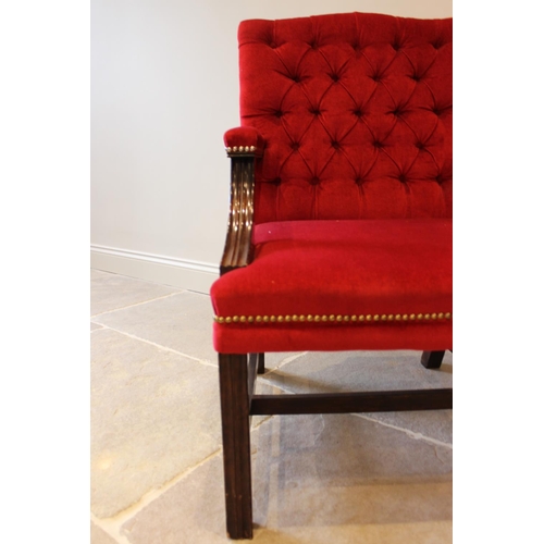 555 - A Gainsborough type button back armchair, the mahogany frame upholstered in a crimson velvet and rai... 