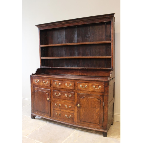 558 - A George III oak North Walian dresser, the high back with a moulded cornice, over three enclosed she... 