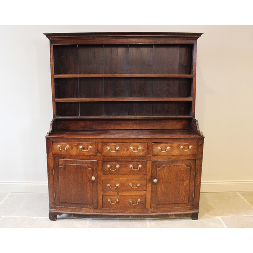 558 - A George III oak North Walian dresser, the high back with a moulded cornice, over three enclosed she... 