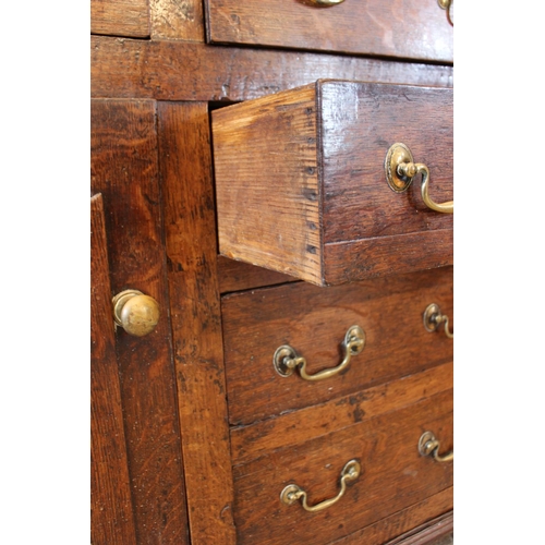 558 - A George III oak North Walian dresser, the high back with a moulded cornice, over three enclosed she... 