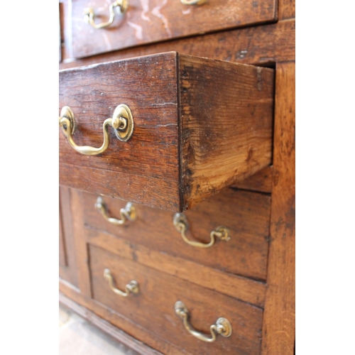 558 - A George III oak North Walian dresser, the high back with a moulded cornice, over three enclosed she... 