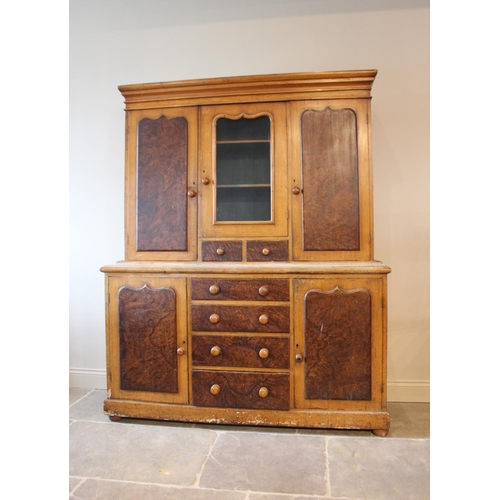 564 - A Victorian scumbled pine housekeepers cupboard, the moulded cornice above a central glazed door ove... 