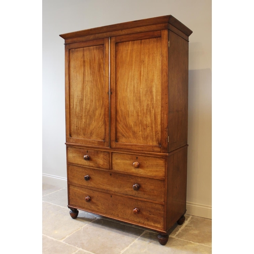 566 - A mid-19th century mahogany linen press, the angular cornice above a pair of panelled cupboard doors... 